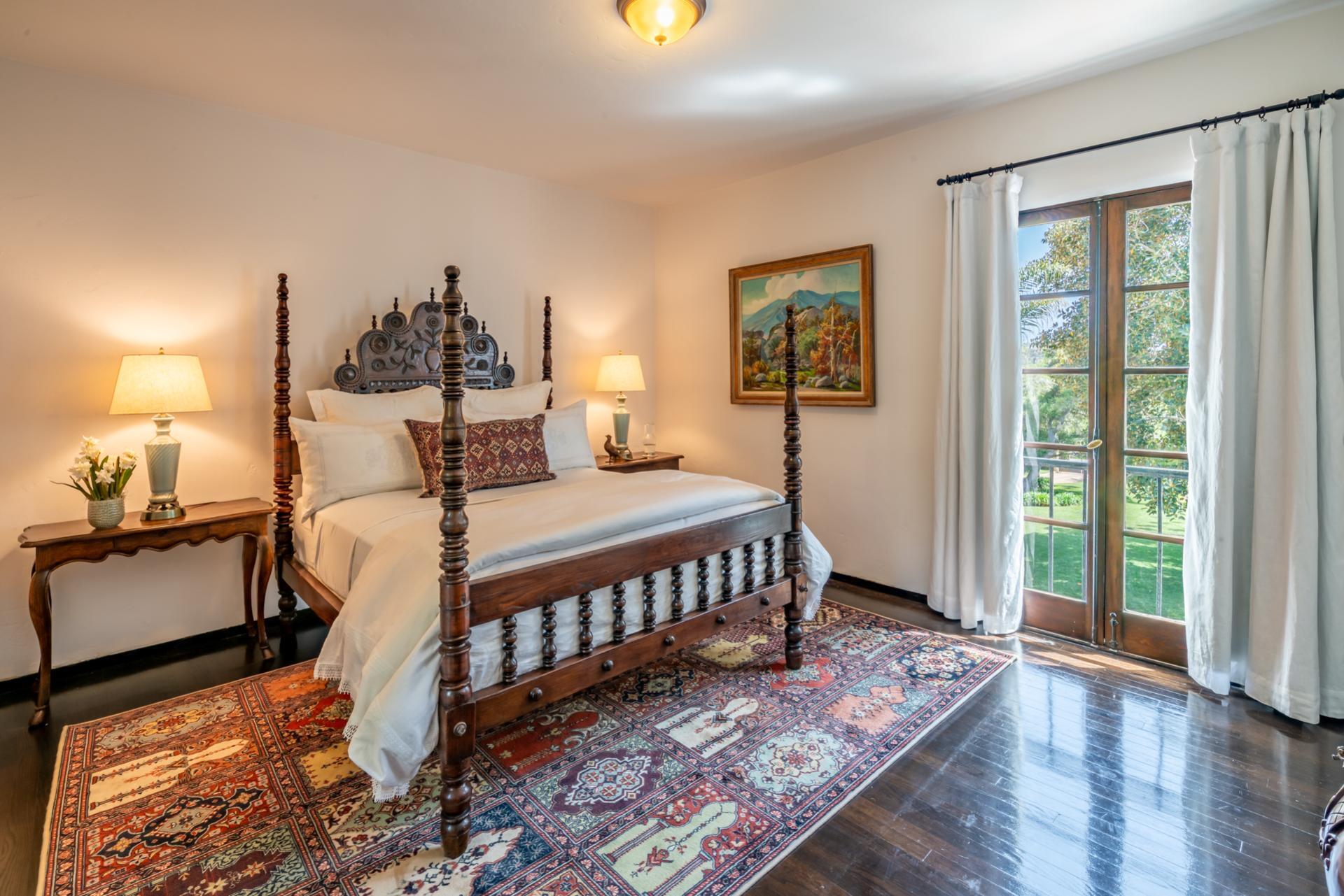 1098 Golf Road Montecito, CA 93108 - Photo 48 of 62 a bedroom with a bed a dresser and wooden floor