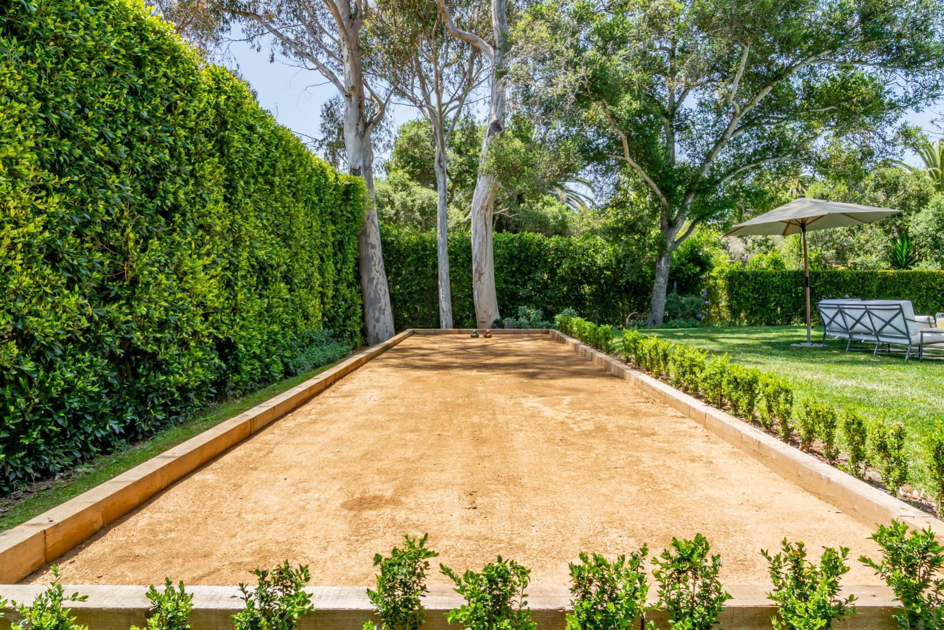 1098 Golf Road Montecito, CA 93108 - Photo 8 of 62 a view of a swimming pool with a garden and trees