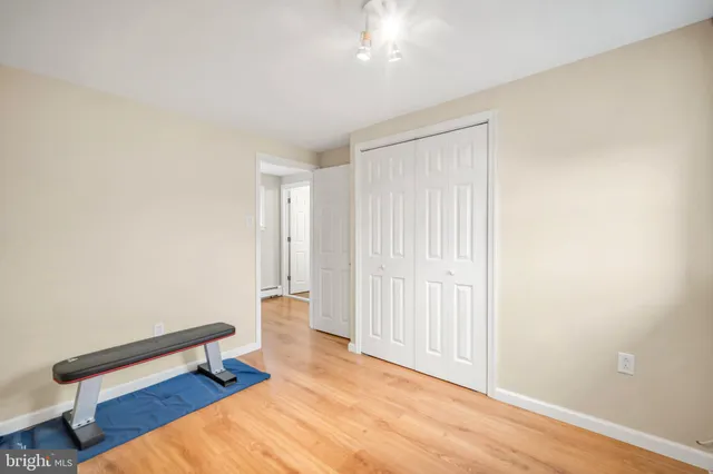 a view of room with wooden floor and fan