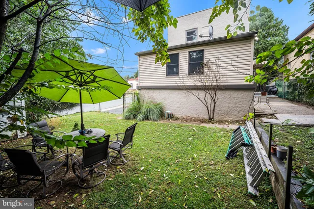 a backyard of a house with table and chairs