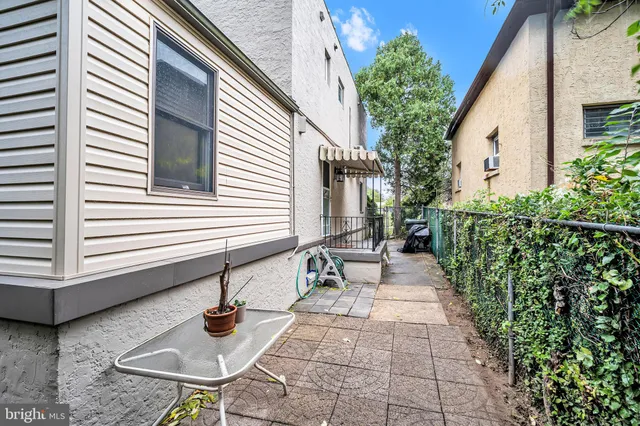 a view of house with backyard and sitting area