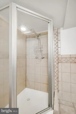 a bathroom with a glass shower door