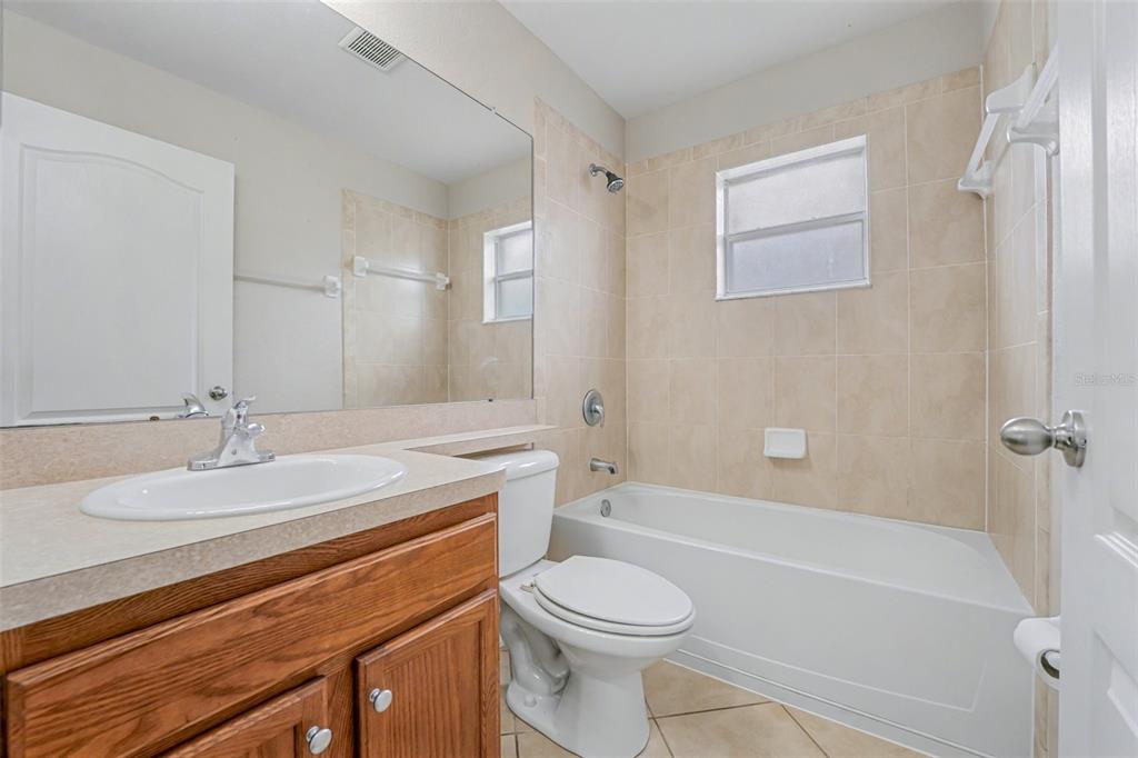 865 Terranova Road Winter Haven, FL 33884 - Photo 11 of 12 a bathroom with a sink a toilet and shower