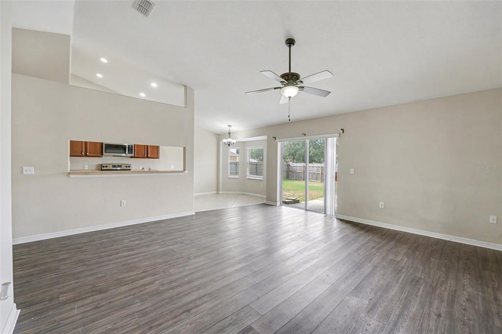 865 Terranova Road Winter Haven, FL 33884 - Photo 3 of 12 a view of an empty room with a window and wooden floor