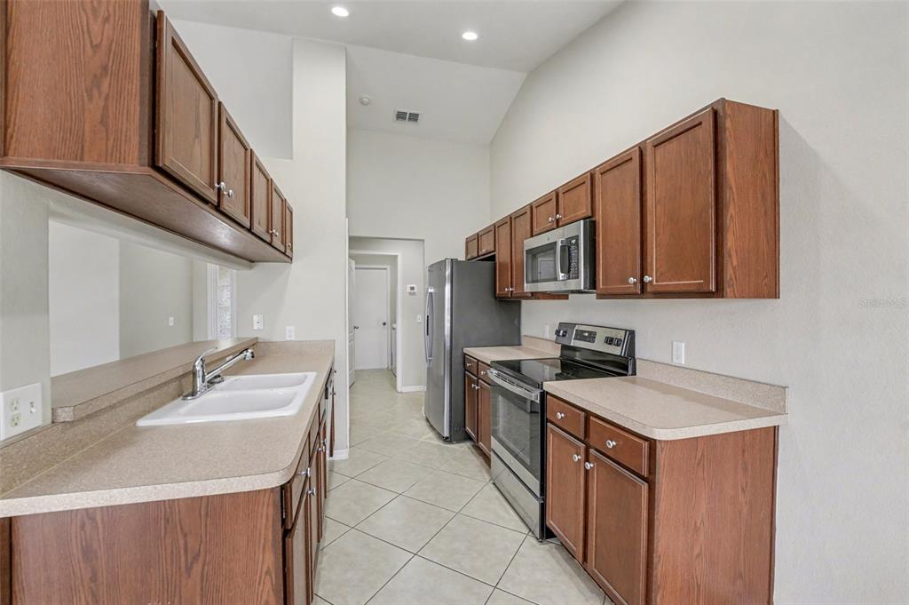 865 Terranova Road Winter Haven, FL 33884 - Photo 4 of 12 a kitchen with stainless steel appliances granite countertop a sink stove and microwave