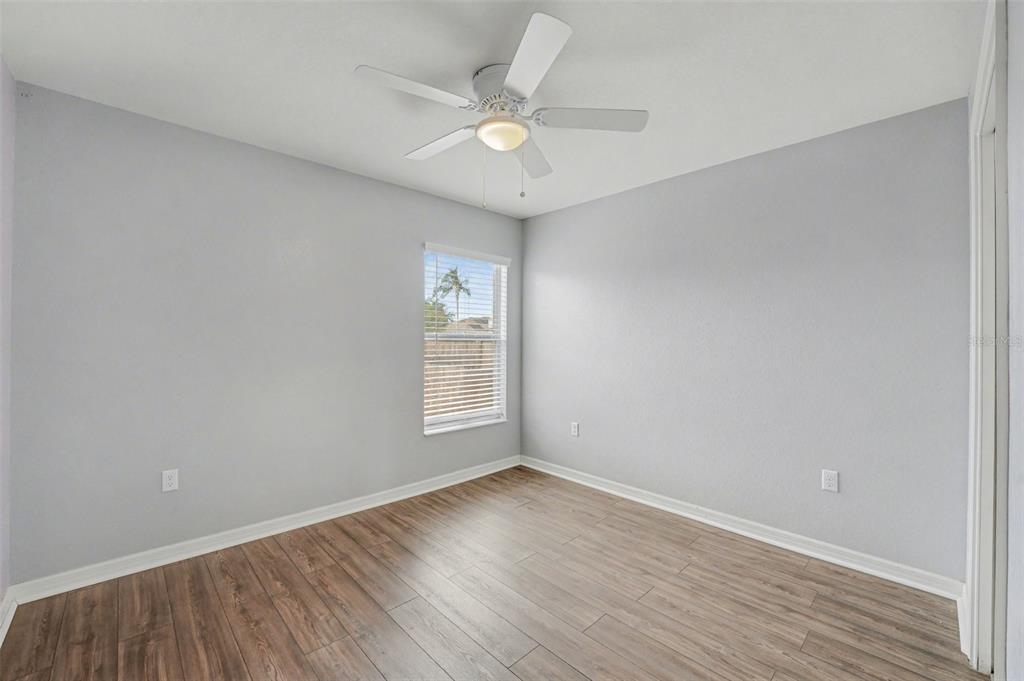 865 Terranova Road Winter Haven, FL 33884 - Photo 7 of 12 an empty room with wooden floor and windows