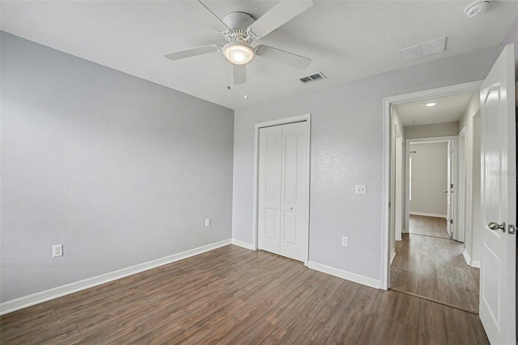 865 Terranova Road Winter Haven, FL 33884 - Photo 8 of 12 wooden floor in an empty room with a window
