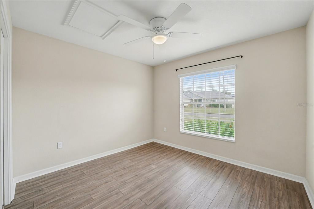 865 Terranova Road Winter Haven, FL 33884 - Photo 9 of 12 an empty room with wooden floor and windows