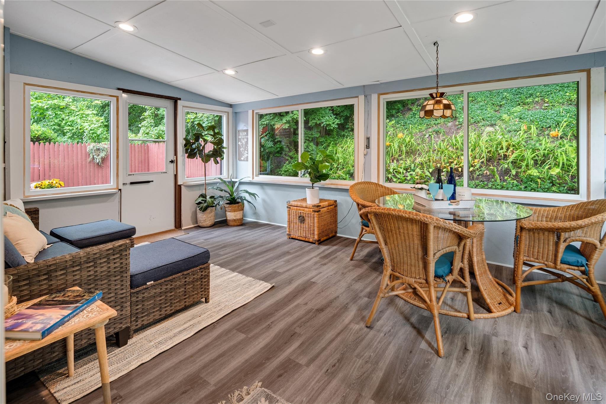 7 Ogden Road Ossining, NY 10562 - Photo 4 of 49 The three-season room, with walls of windows offering lush landscaped views and a door leading to the wraparound deck, extends the main living space and is the perfect spot to relax and entertain.