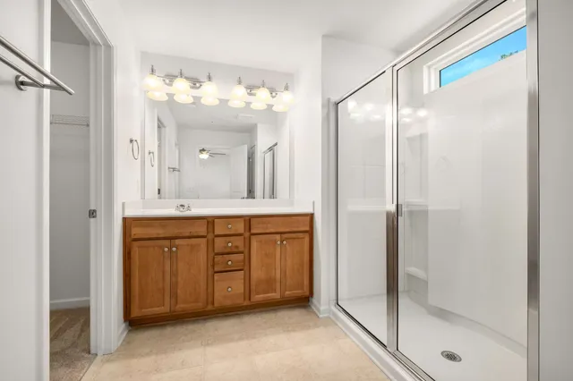 a spacious bathroom with a double vanity sink mirror and a shower