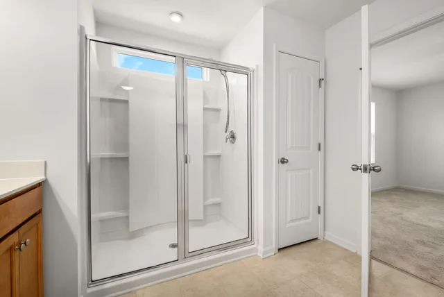 a bathroom with a glass shower door