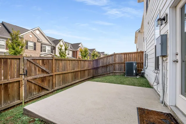a view of a house with wooden fence
