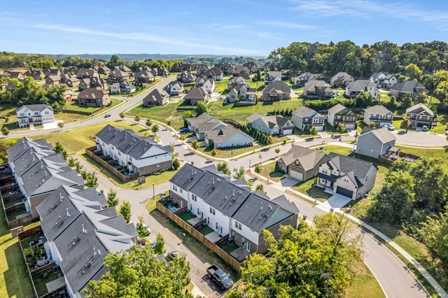 an aerial view of residential houses with outdoor space