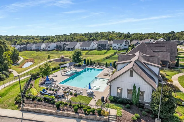 a view of a house with a garden and lake view
