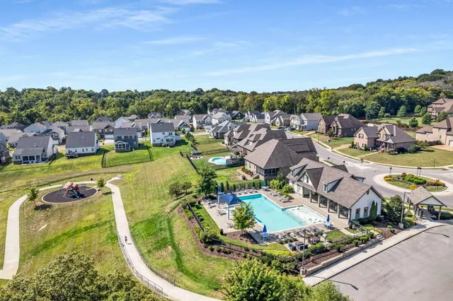 an aerial view of residential houses with outdoor space and swimming pool