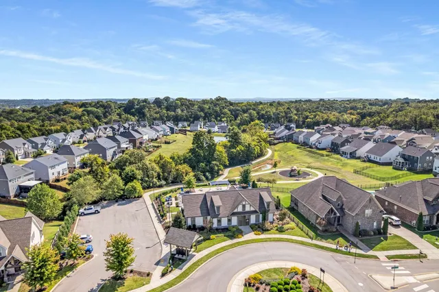 an aerial view of residential houses with outdoor space and swimming pool