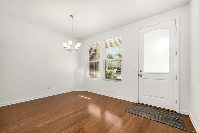 a view of a room with wooden floor and windows