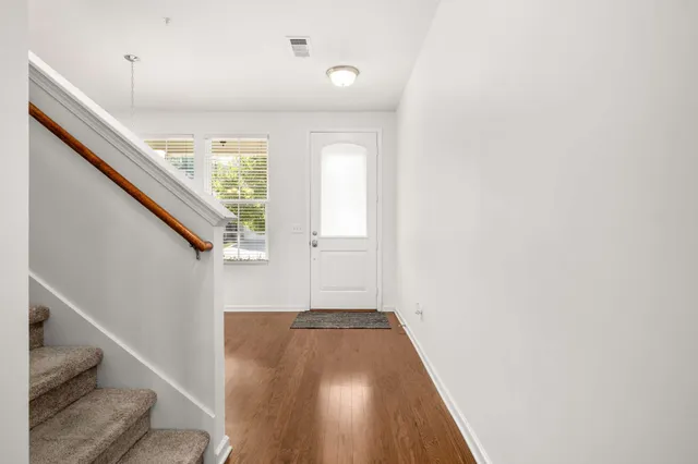a view of entryway and hall with wooden floor