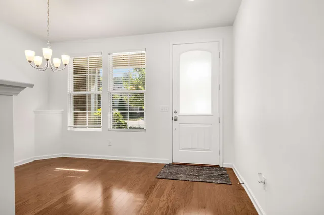 a view of a livingroom with wooden floor and a window