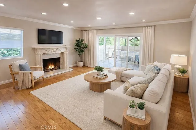 a living room with furniture fireplace and window