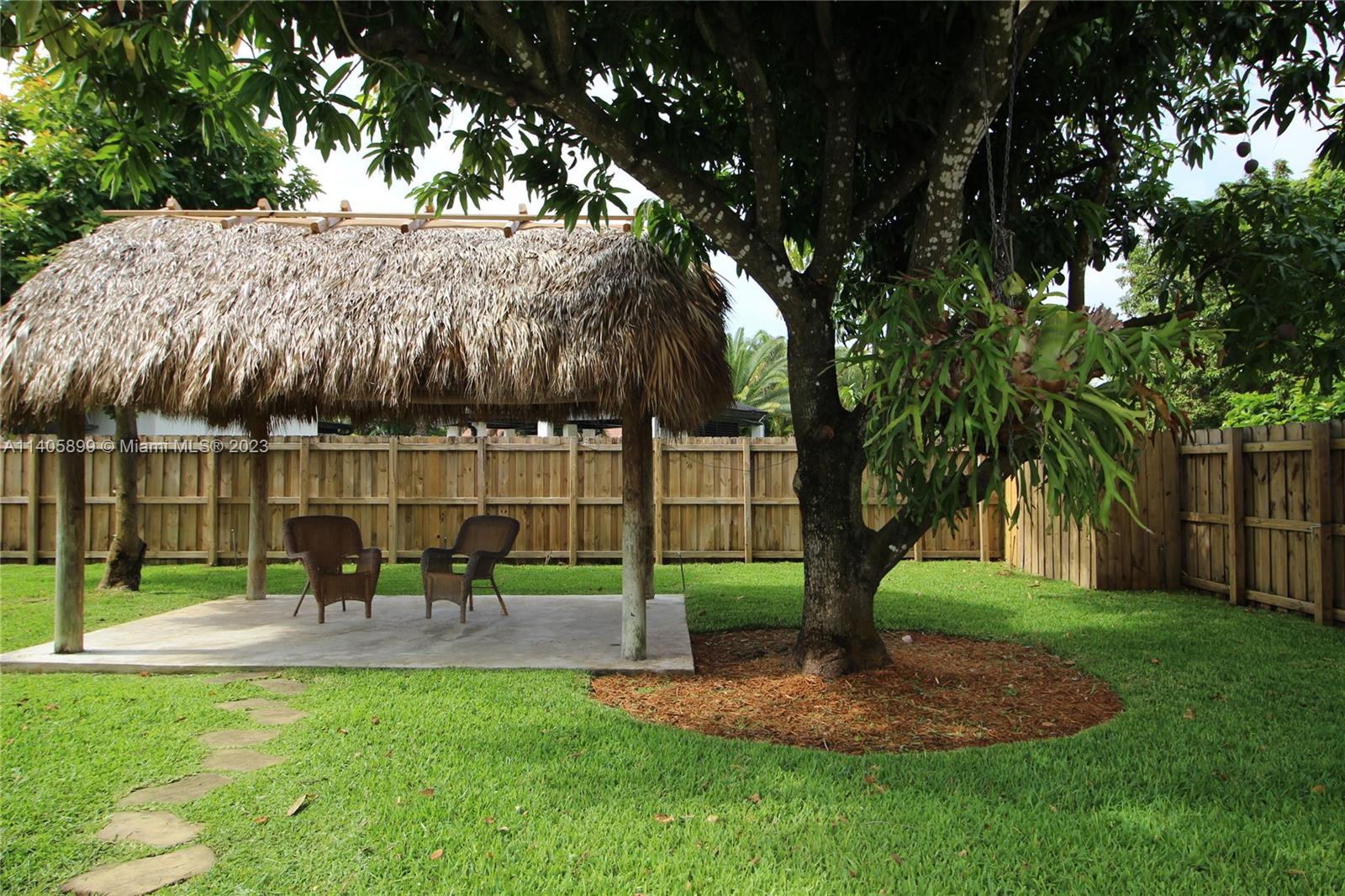 10810 Southwest 28th Street Miami, FL 33165 - Photo 15 of 45 a garden view with a sitting space