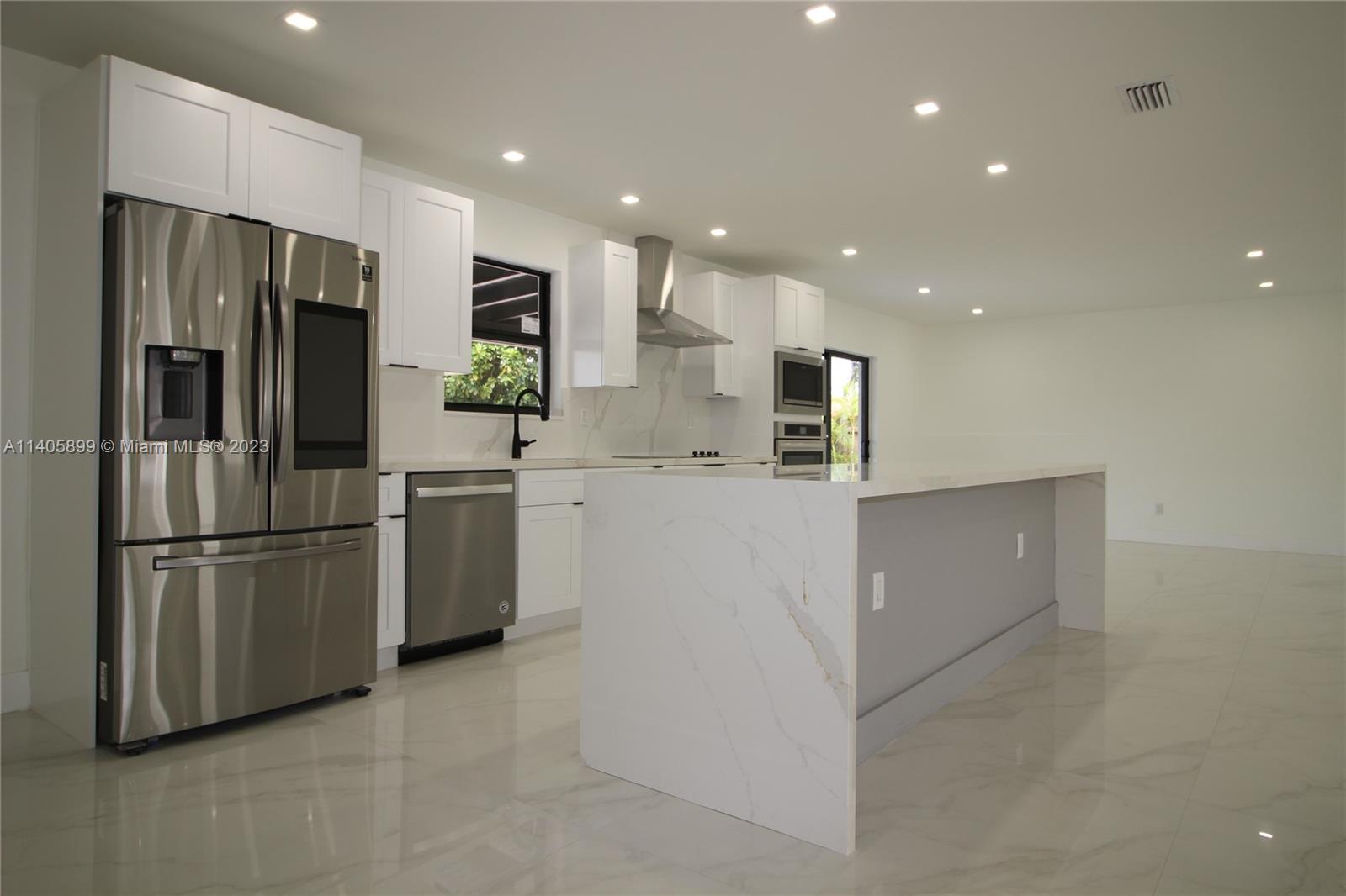 10810 Southwest 28th Street Miami, FL 33165 - Photo 16 of 45 a kitchen with stainless steel appliances refrigerator and microwave