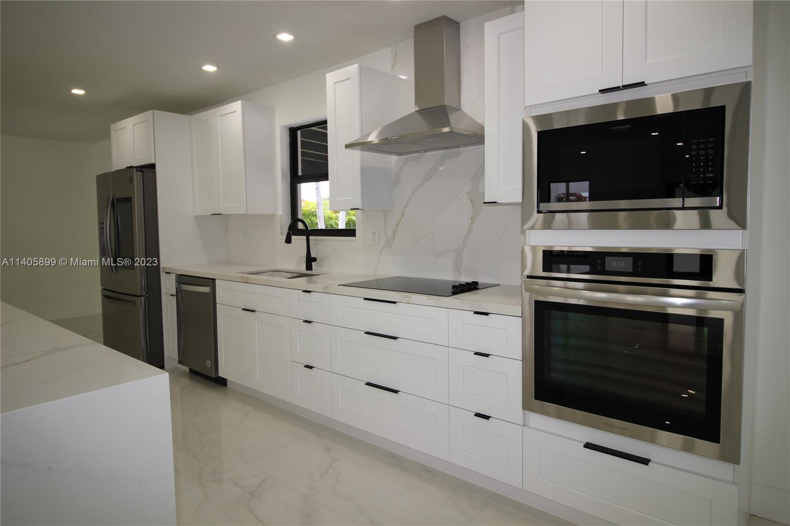 10810 Southwest 28th Street Miami, FL 33165 - Photo 17 of 45 a kitchen with stainless steel appliances a stove microwave and refrigerator