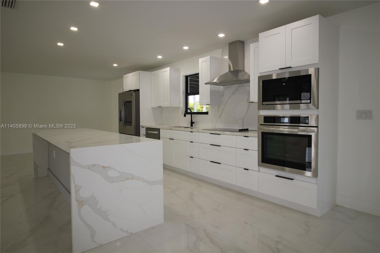 10810 Southwest 28th Street Miami, FL 33165 - Photo 18 of 45 a kitchen with stainless steel appliances a stove sink and microwave