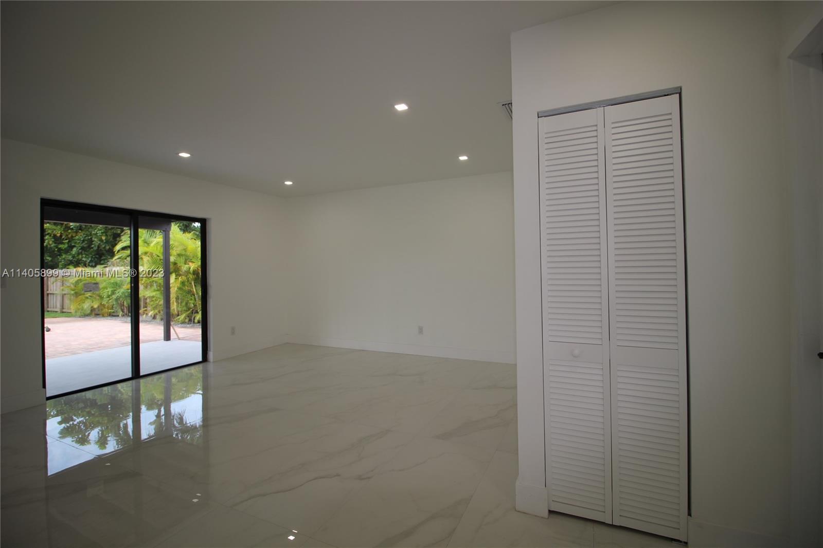10810 Southwest 28th Street Miami, FL 33165 - Photo 21 of 45 an empty room with sliding door