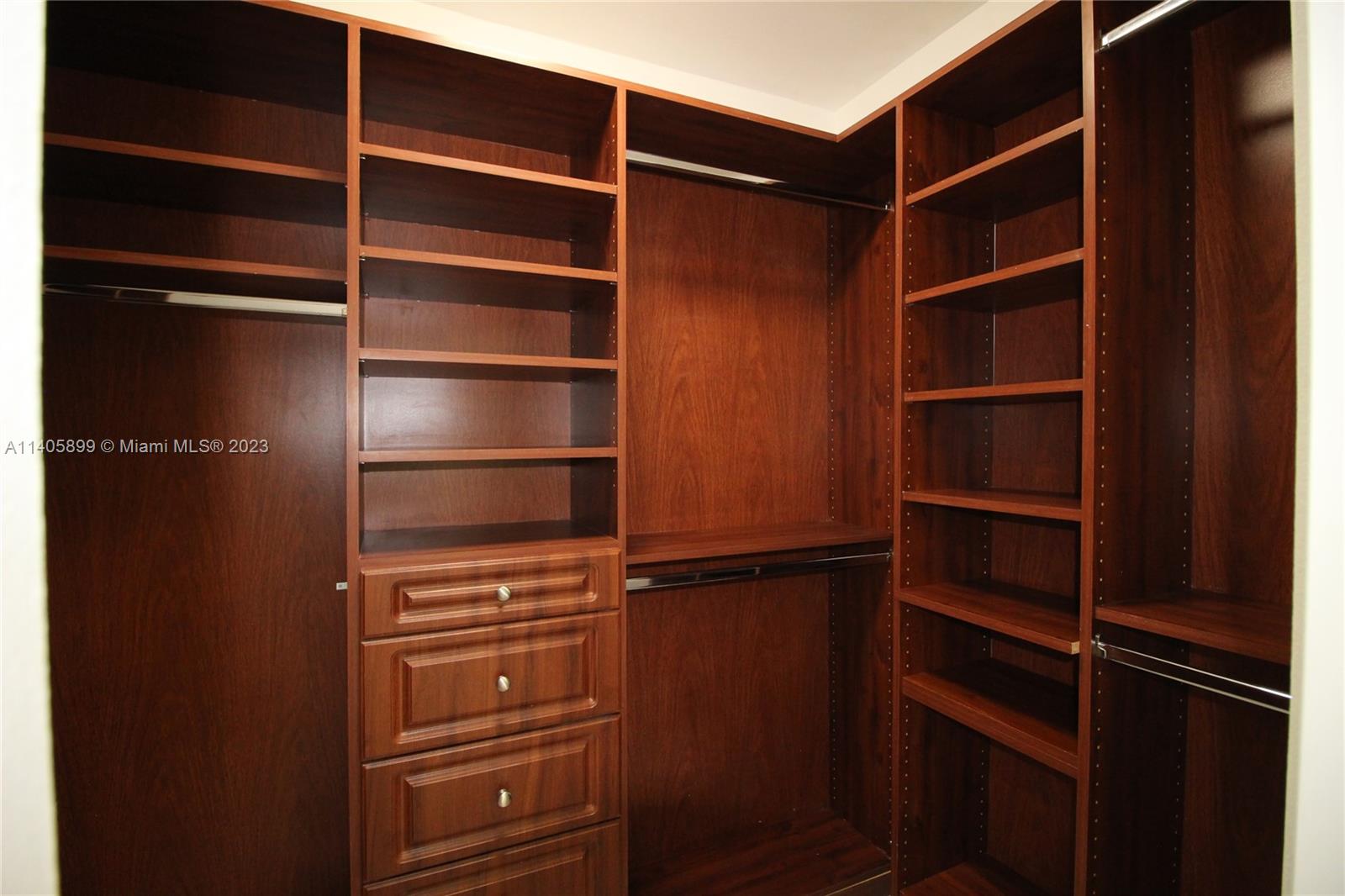 10810 Southwest 28th Street Miami, FL 33165 - Photo 31 of 45 a view of walk in closet with empty racks
