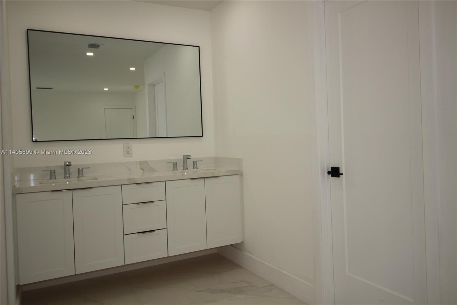 10810 Southwest 28th Street Miami, FL 33165 - Photo 33 of 45 a bathroom with a double vanity sink and mirror