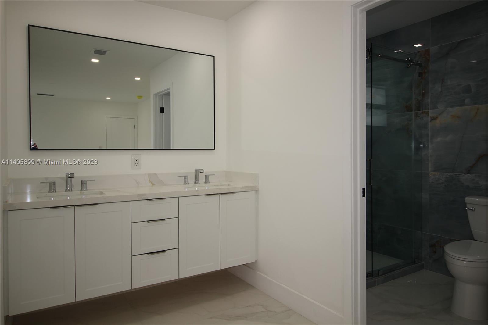 10810 Southwest 28th Street Miami, FL 33165 - Photo 34 of 45 a bathroom with a toilet sink and mirror