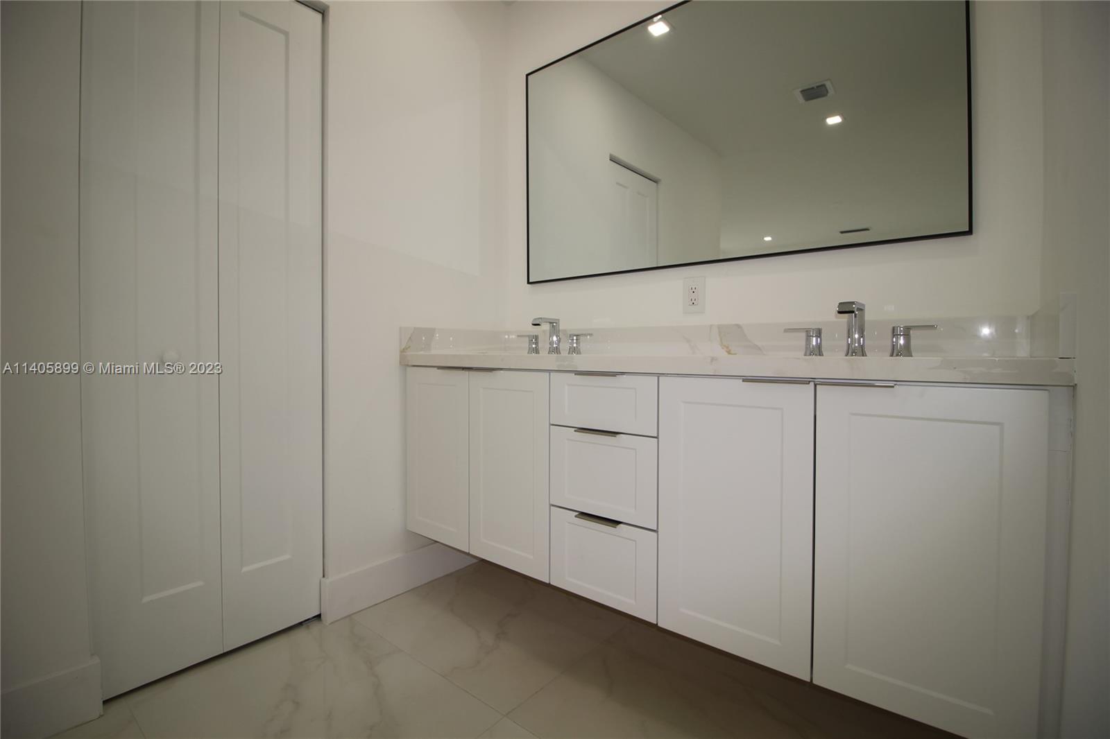 10810 Southwest 28th Street Miami, FL 33165 - Photo 35 of 45 a bathroom with a sink and a mirror