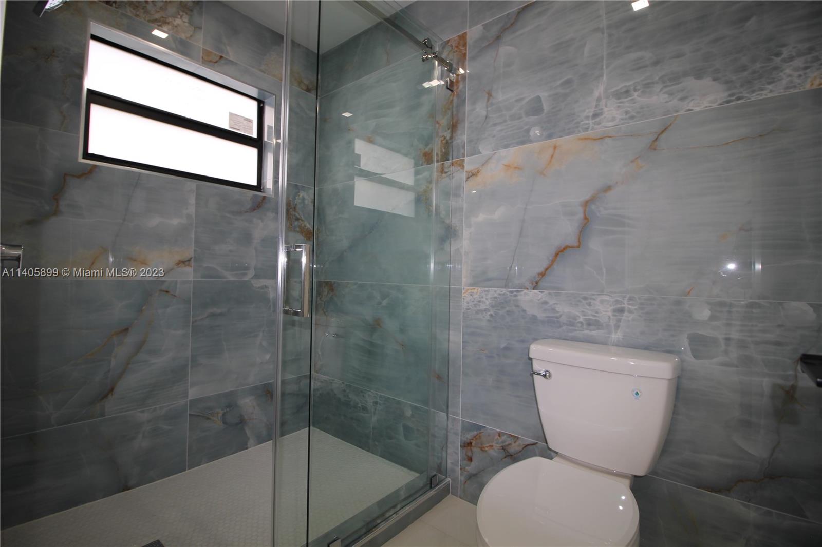 10810 Southwest 28th Street Miami, FL 33165 - Photo 36 of 45 a bathroom with a toilet and a shower