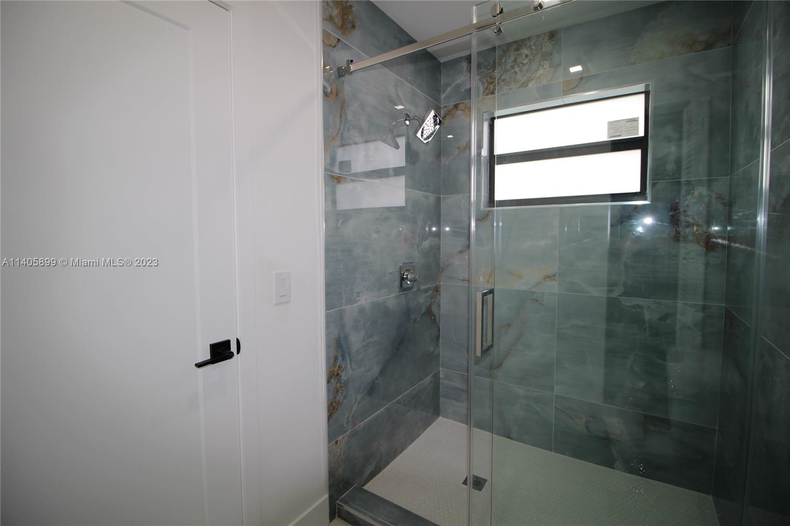 10810 Southwest 28th Street Miami, FL 33165 - Photo 37 of 45 a bathroom with a glass shower door