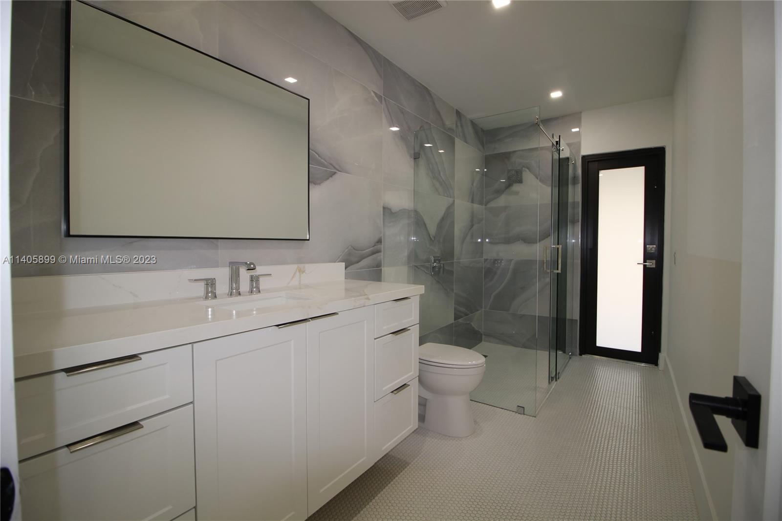 10810 Southwest 28th Street Miami, FL 33165 - Photo 38 of 45 a bathroom with a double vanity sink toilet and shower