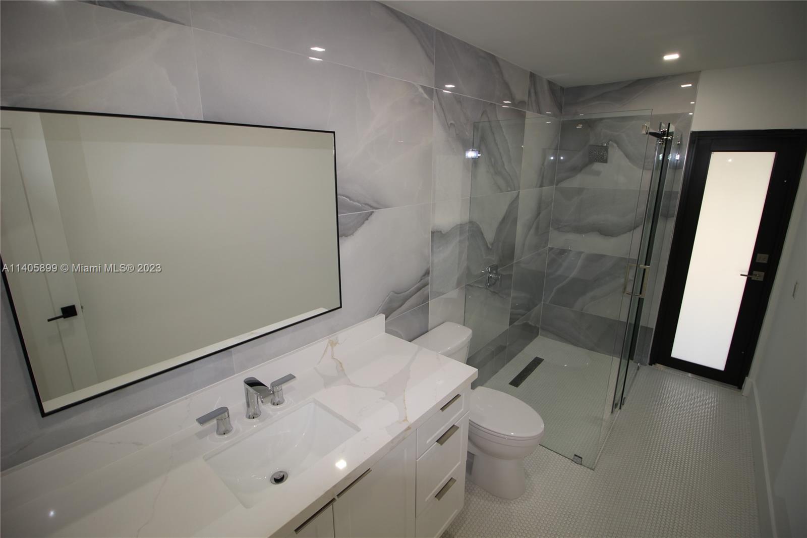 10810 Southwest 28th Street Miami, FL 33165 - Photo 39 of 45 a bathroom with a sink a toilet and shower