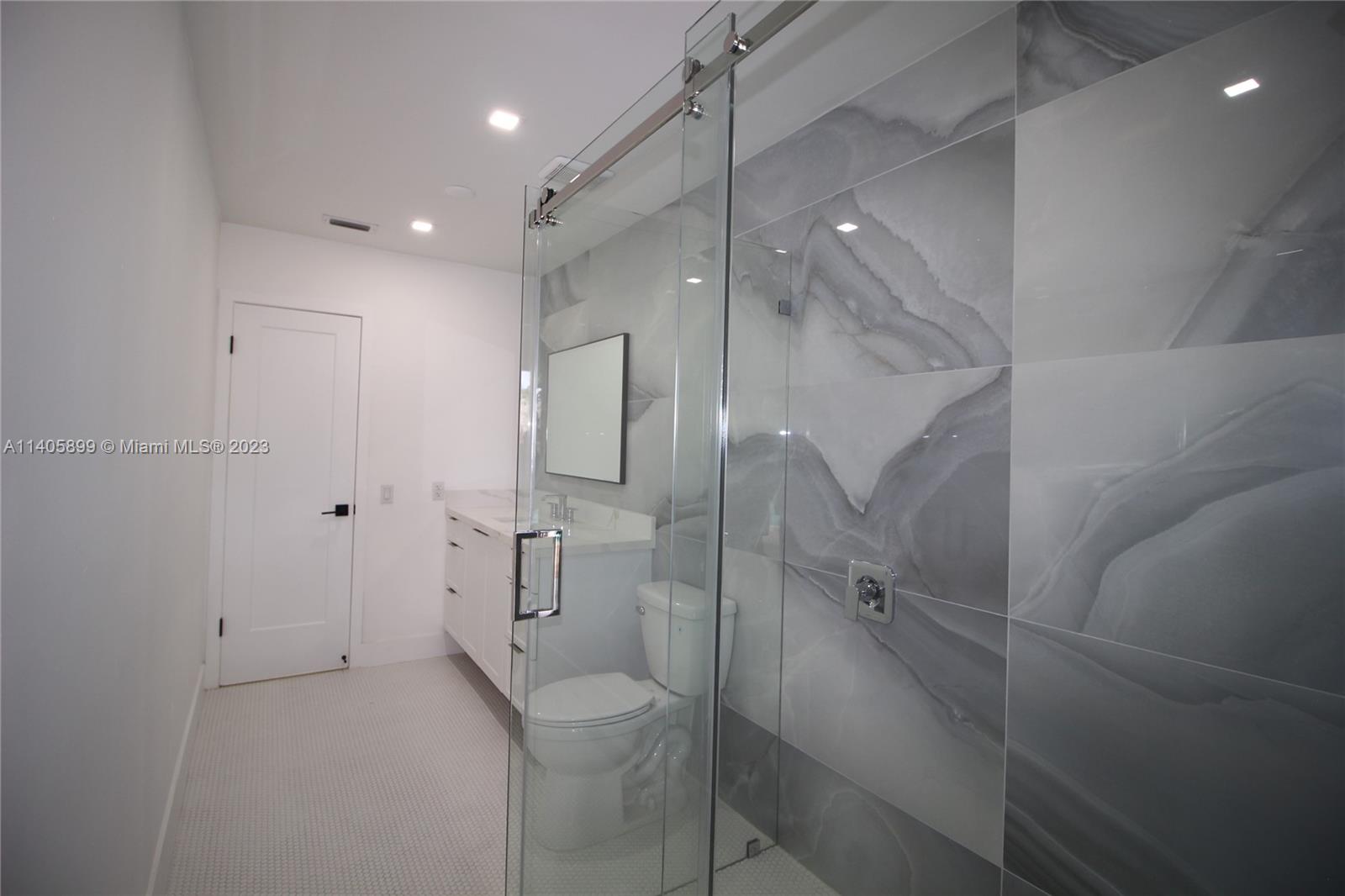 10810 Southwest 28th Street Miami, FL 33165 - Photo 40 of 45 a bathroom with a shower and toilet