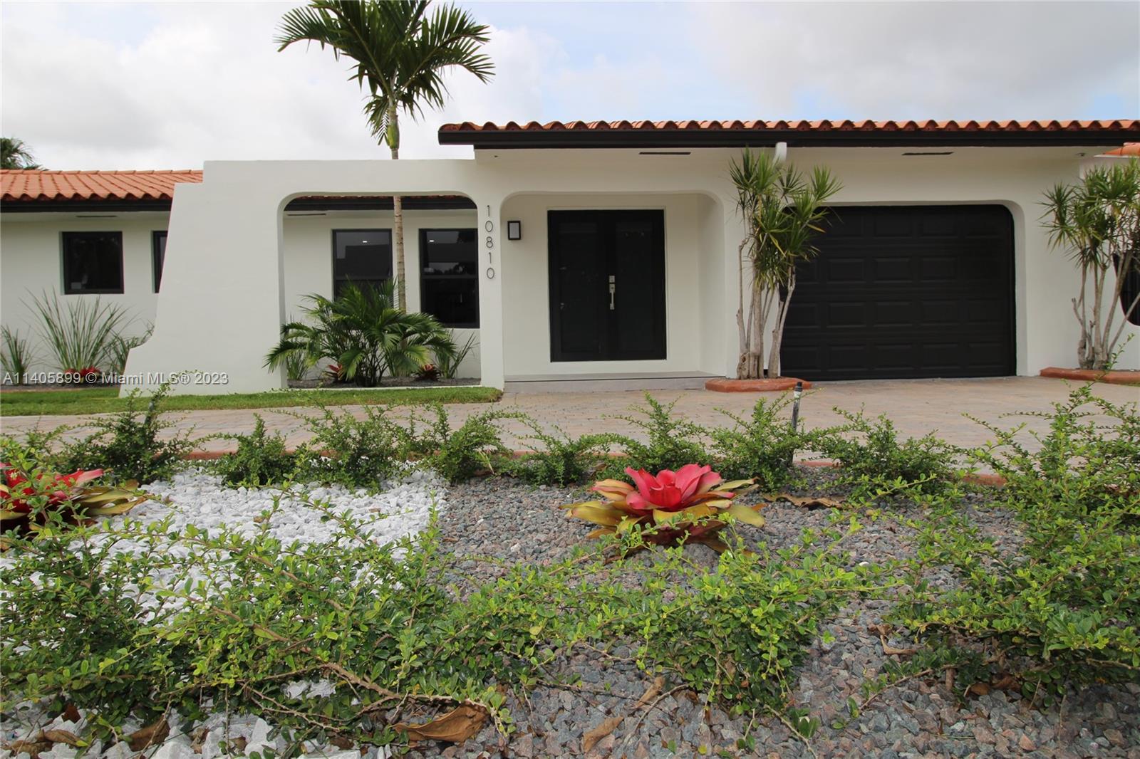 10810 Southwest 28th Street Miami, FL 33165 - Photo 4 of 45 a front view of a house with a yard