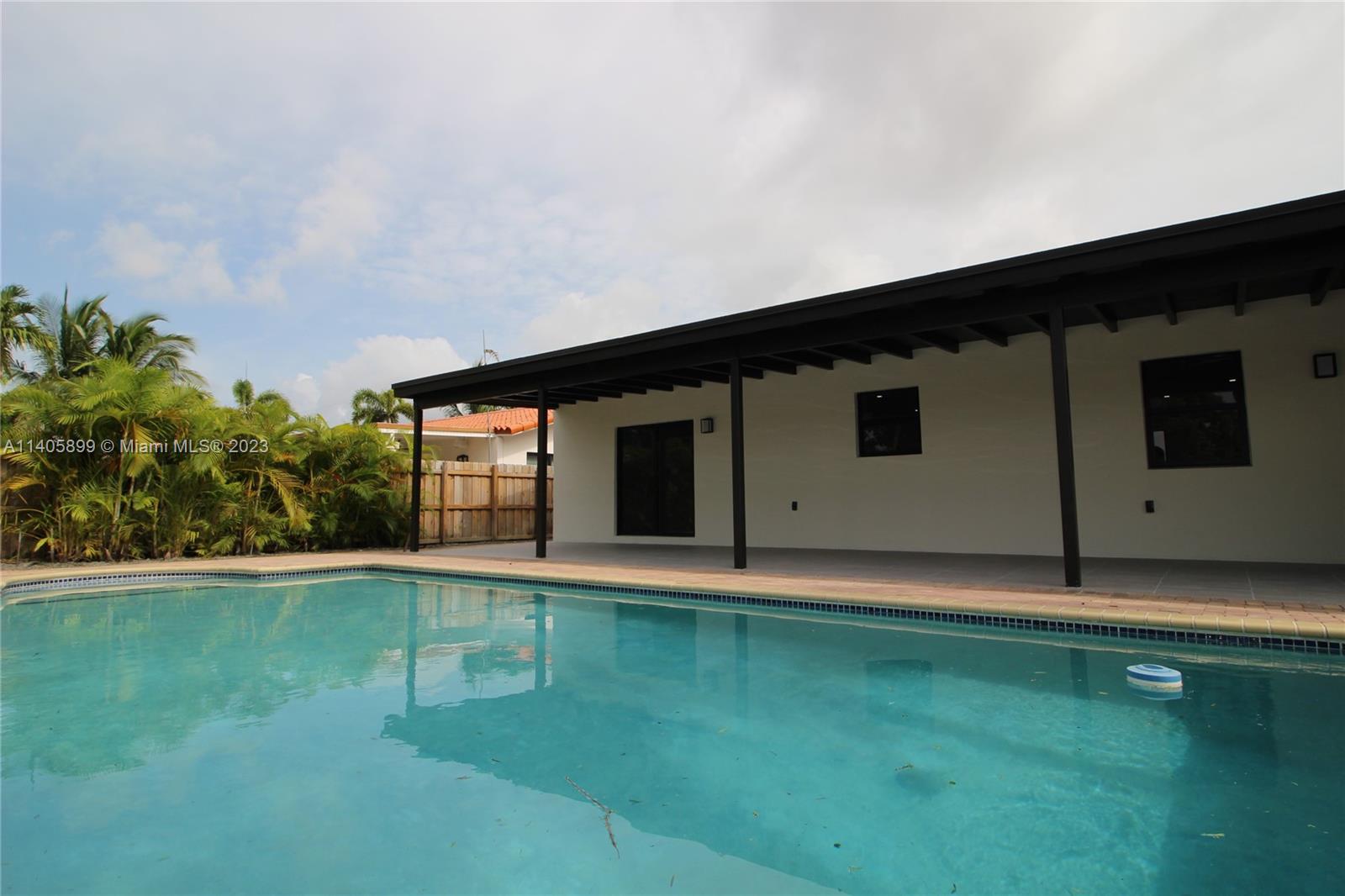 10810 Southwest 28th Street Miami, FL 33165 - Photo 8 of 45 a backyard of a house with lots of green space and plants