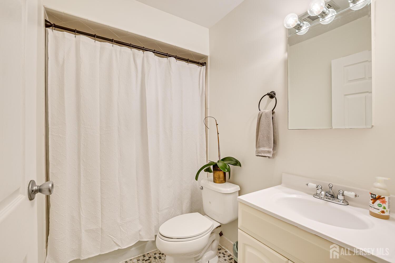 30-5 Prospect Street, Unit 2 Metuchen, NJ 08840 - Photo 17 of 23 a white toilet sitting next to a bathroom sink