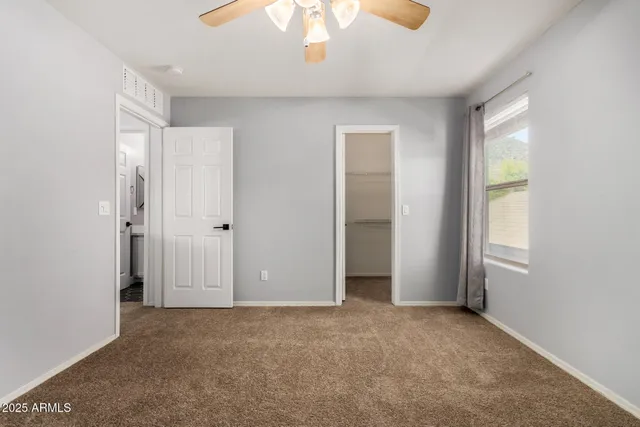 an empty room with windows and closet