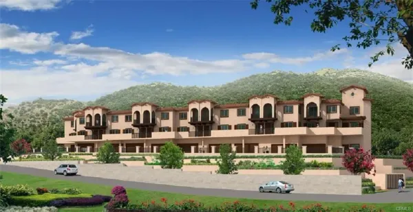 a front view of a residential apartment building with a yard