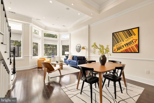 a dining room with furniture and wooden floor