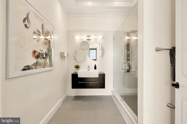 a bathroom with a sink vanity tub and shower