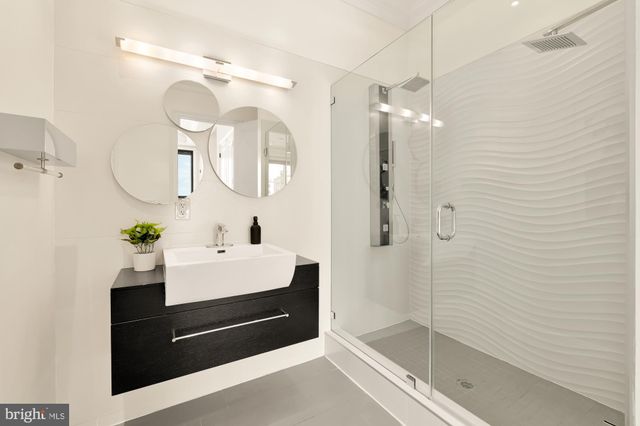 a spacious bedroom with a bed and wooden floor