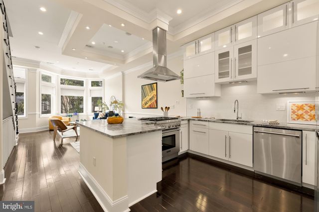 a kitchen with counter top space a sink appliances and cabinets