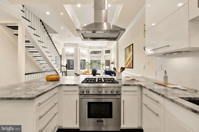 a kitchen with stainless steel appliances granite countertop a stove and a sink