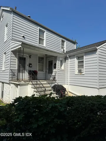 a front view of a house with a garden