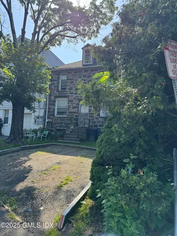 a view of swimming pool with sitting area and garden